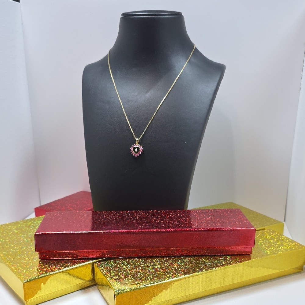 Silver bath with gold and pink gemstone.